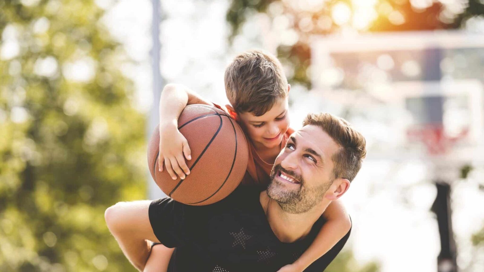 A,Man,And,Young,Boy,Playing,Basketball,On,A,Court,